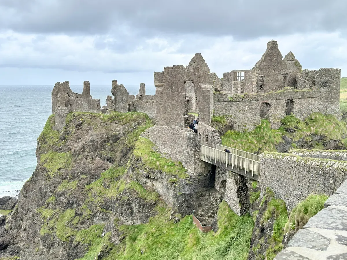 Dunluce Castle on its cliff on the Antrim coast on a Northern Ireland tour