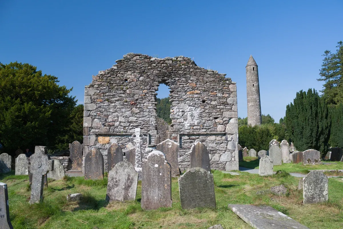 The round tower and cathedral ruin at Glendalough on an Ireland tour from Dublin