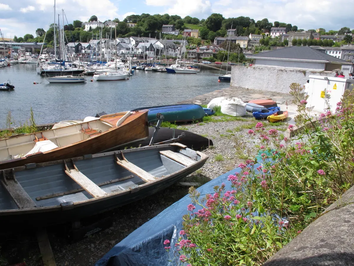 Rowing boats on the shore of Kinsale harbour on a vacation tours of Ireland south west itinerary