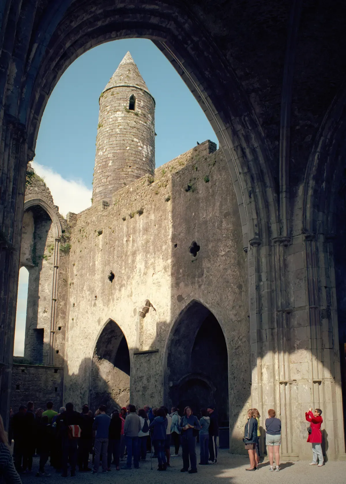 The cathedral ruins and round tower on the Rock of Cashel, seen on vacation tours of Ireland